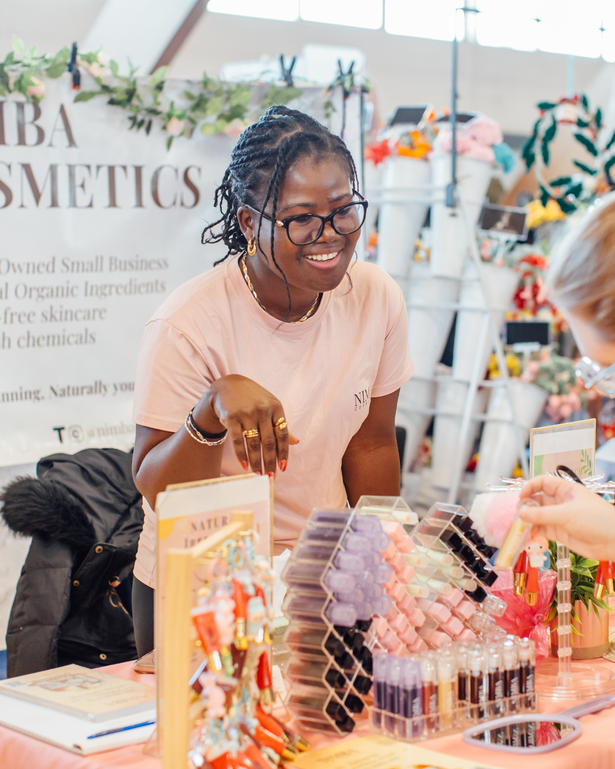 Vendor at a marketplace stall of Black-owned brands and makers