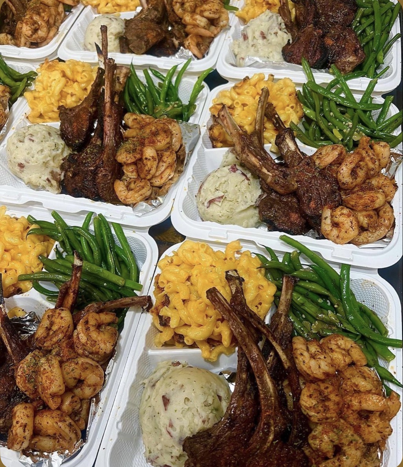 Trays of lamb chops, shrimp, mac and cheese and green beans