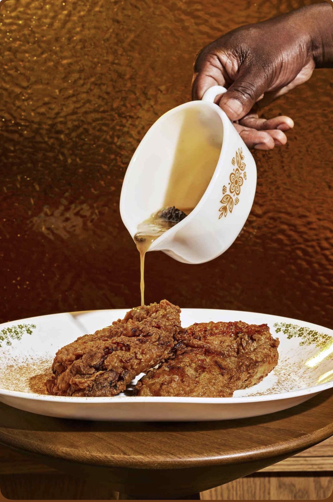 Golden fried chicken with honey being poured over it